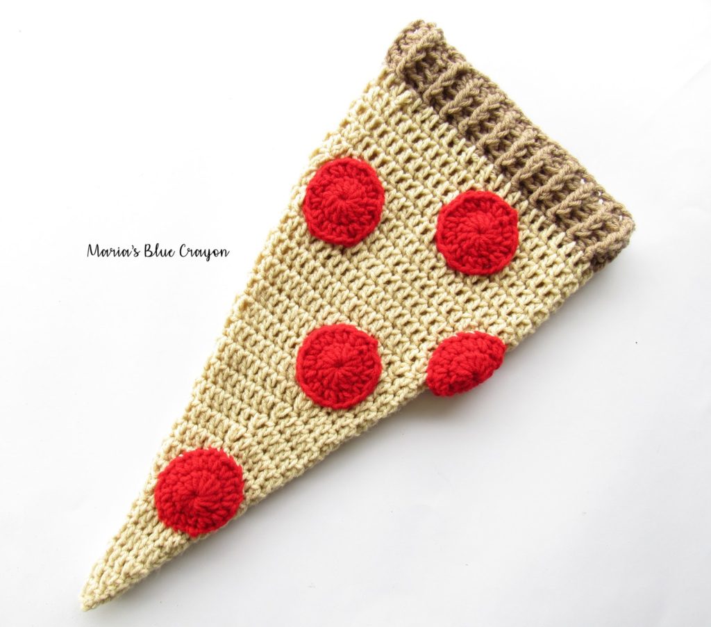 Crochet beanie made to look like a slice of pepperoni pizza on a white background.