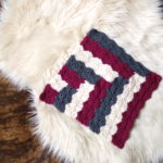 a shell stitch crochet afghan block made in a log-cabin inspired pattern