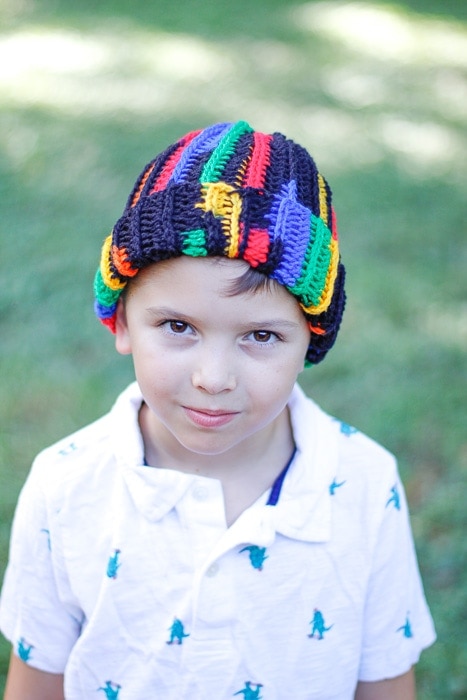 Little boy wearing a multi-color ribbed crochet beanie