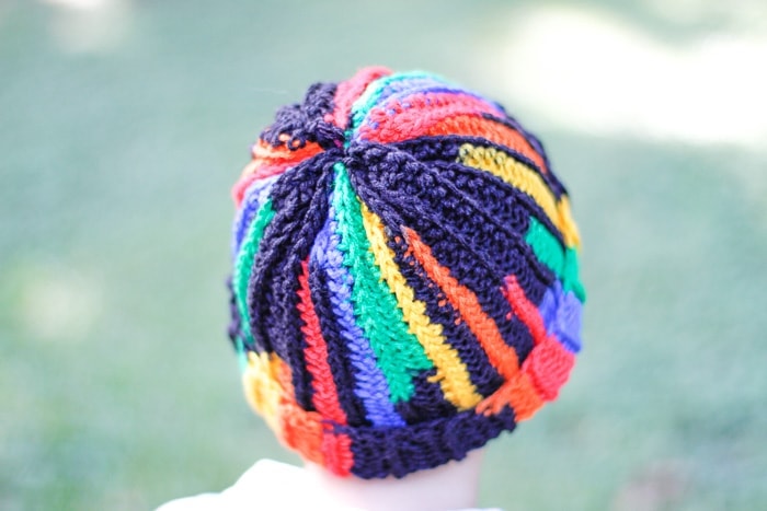 Close up of the back of a multi-colored ribbed crochet beanie.