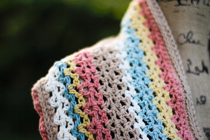 Close up of stitches on pastel rainbow crochet scarf. 