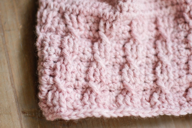 A close up of the Simple Cable Brimmed Beanie laid flat on a tray.