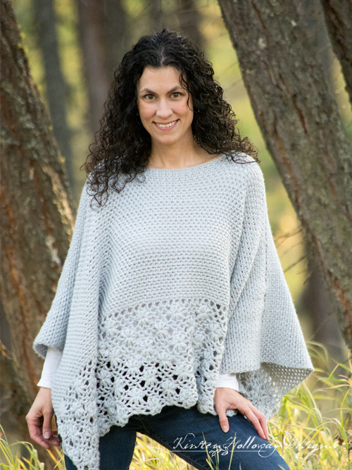 Woman standing outside wearing a gray crochet poncho. 