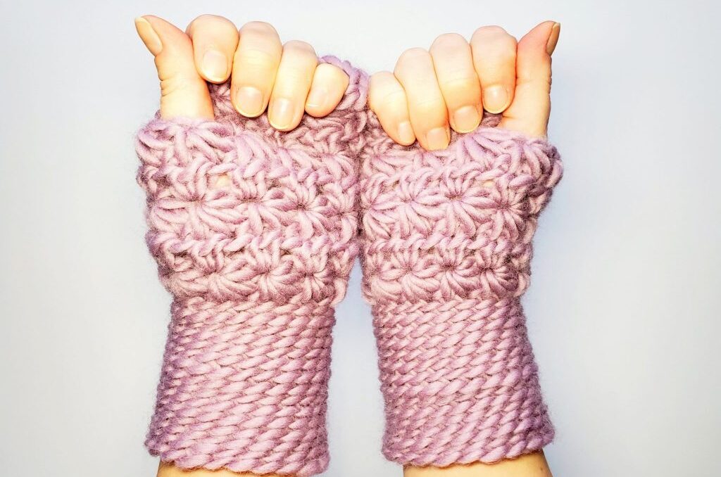hands wearing crochet fingerless gloves