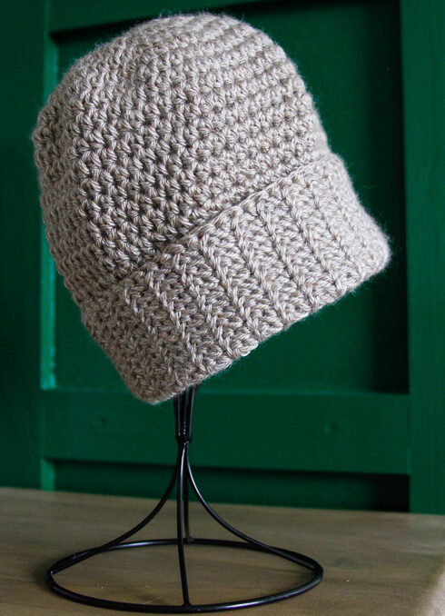 Close up of tan crochet hat. 