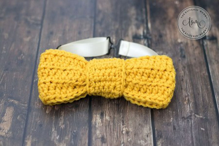A yellow crochet bow tie
