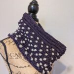 Side view of the polka dot puffs crochet cowl pattern on a mannequin