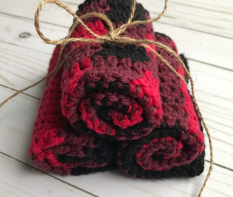 a bundle of 3 rolled crochet dishcloths with a unique buffalo plaid design