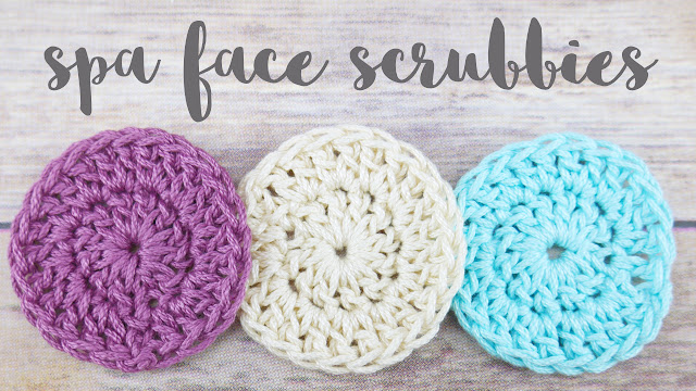 3 crochet spa face scrubbies in purple, white and blue on a table