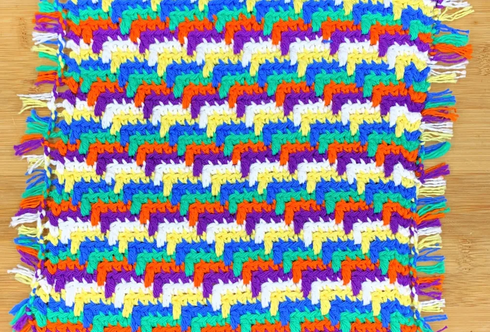a multicolor crochet dishcloth using the apache tears crochet stitch