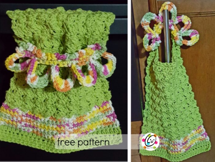 green crochet dish towel with accent color of a yellow, purple, white, green and orange variegated yarn; one hanging on an oven handle and other handing on cabinet handle