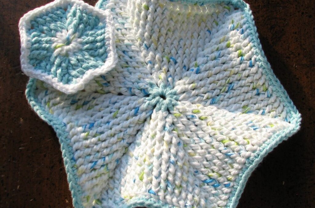 two blue and white crochet hexagons- a small scrubby and a larger dishcloth