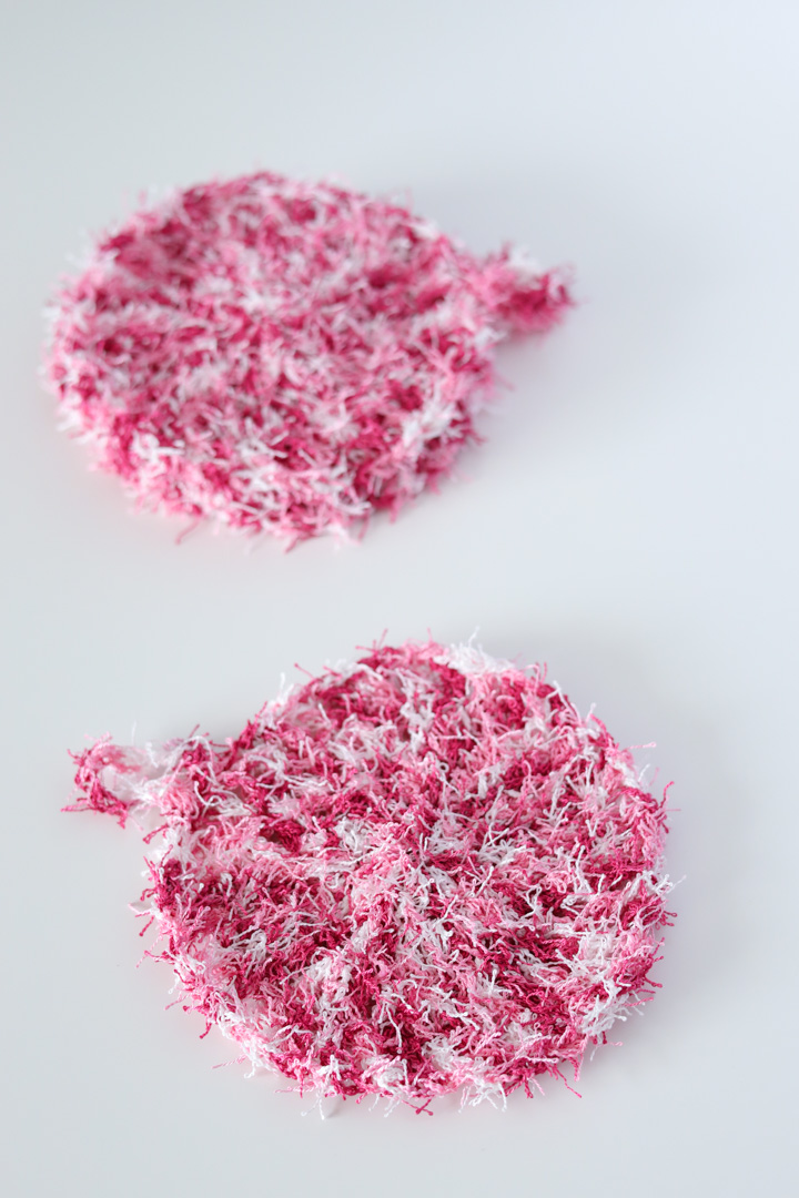 2 pink crochet kitchen scrubbies with hanging loops