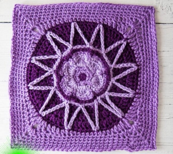 Purple crochet flower square in two different shades of purple on a white background. 