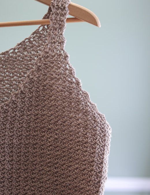 Closeup of the top of a crochet tank top with a v neck