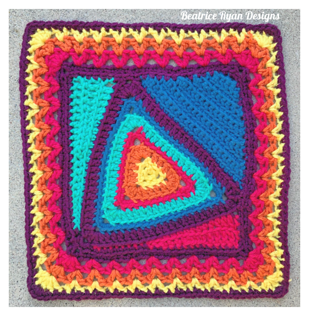 A crocheted colorful afghan square on table. 
