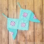 Crocheted granny square crop top on wood background