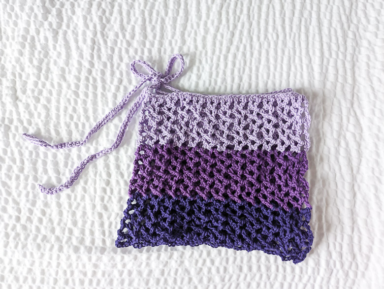 a crochet sarong skirt folded into a square and tied with a bow