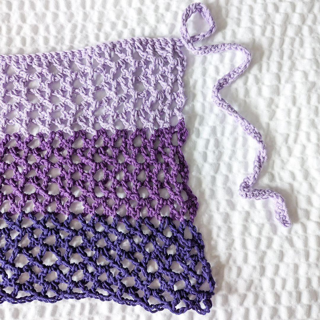 a closeup of the crochet mesh stitch used in the ombre sarong