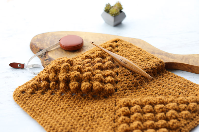 closeup of the crochet bobble stitch texture in a granny square